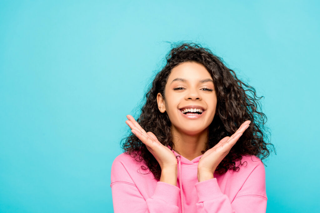 Woman showing off bright white smile makeover for the new year