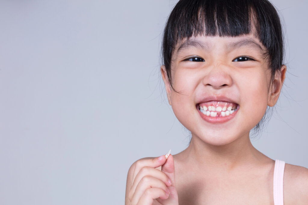 Little girl with a lost tooth. 